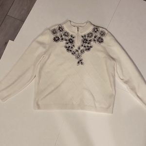 Alfred Dunner acrylic white sweater. Size medium. Front adorned with flowers.